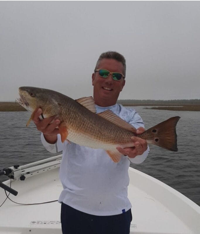 Buddy Moorman holding large redfish