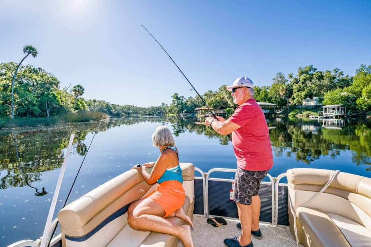 Senior couple fishing from the front of a rented pontoon boat from Steinhatchee Marina