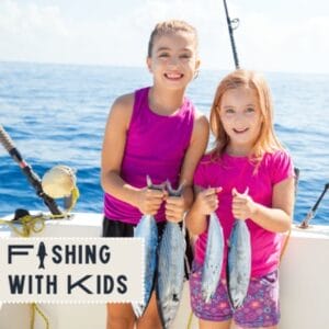 Two girls posing with fish they caught