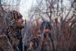 Two men hunting in the woods