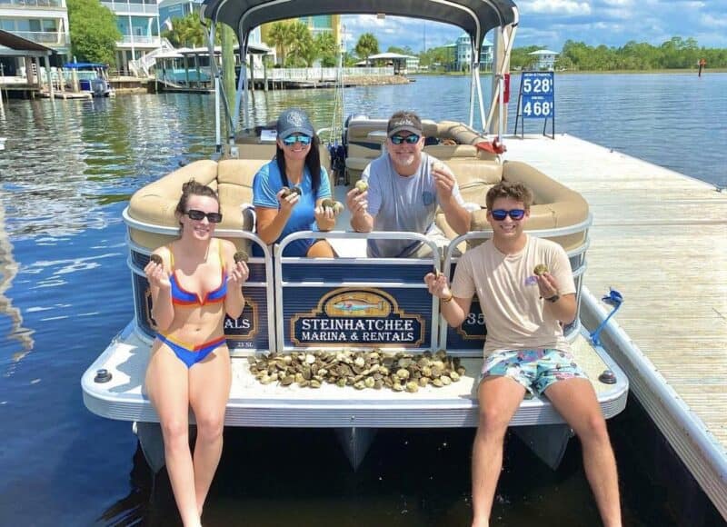 Family posing with a bunch of scallops they caught