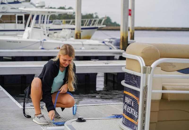 Woman tying boat to a dock